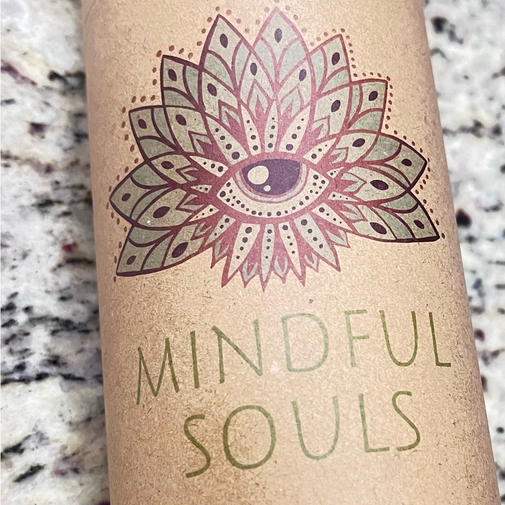 Glass water bottle with amethyst crystals.